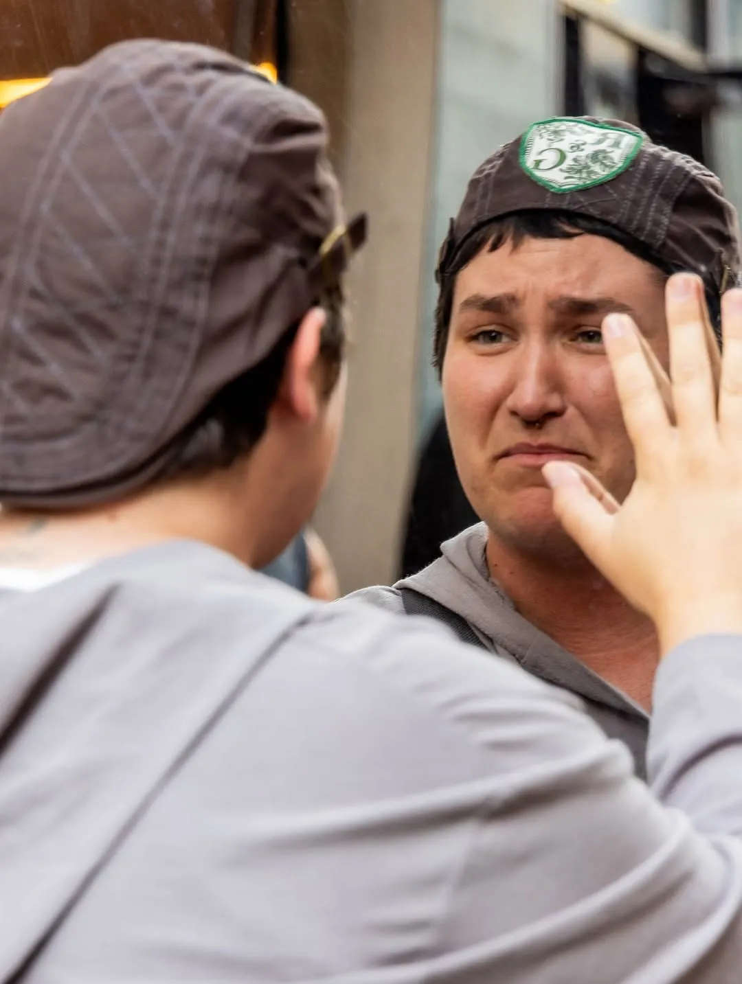 The two leads exchanging a gesture at close range.